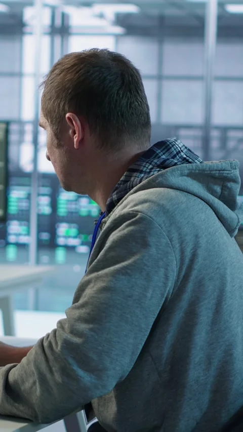 Man requesting help from coworkers after finding bug in data center systems Stock Footage 319577148