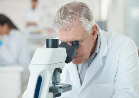 Man, research and microscope for scientist in lab with disease experiment Stock Photos