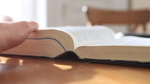 A man researches information in a dictionary. Stock Footage 72776033