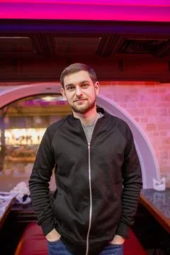 A man in a restaurant stands at the table Stock Photos