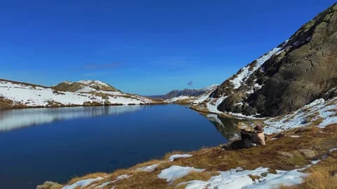 Man Resting by Alpine Lake. Stock Footage 320883955