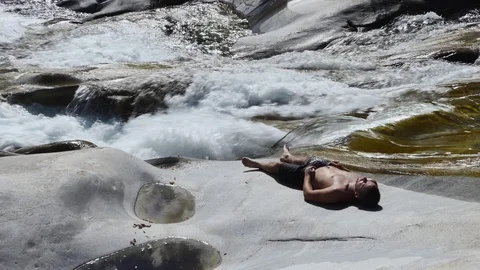 Man resting on alpine riverside Stock Footage 114177435