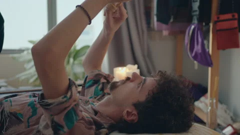 Man Resting on Bed with Sand Timer Stock Footage 235659107