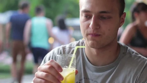 Man resting in a cafe. He communicates and drinks a drink Stock-Footage 77627688