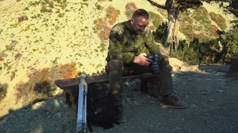 A man is resting in a camp in the mountains Stockbeeldmateriaal 143610459