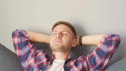 Man resting on the couch at home. hands behind his head Stock Footage 221262055