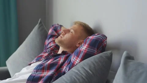 Man resting on the couch at home. hands behind his head Stock Footage 221397882
