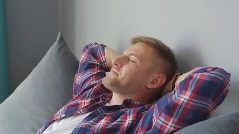 Man resting on the couch at home. hands behind his head Stock Footage 221398805
