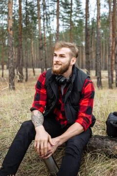 Man resting in the forest and drinking tea from the thermos Stock Photos