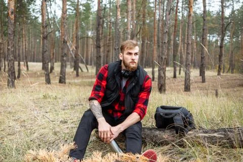 Man resting in the forest and drinking tea from the thermos Stock Photos