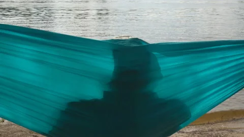 Man resting in a hammock in 4K Stock Footage 160892223