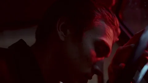 Man Resting Head on Steering Wheel, Reflecting Alone in Car at Night Stock Footage 307550833