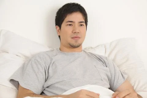 Man resting in his bed Stock Photos