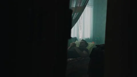 A man is resting in an old ex Soviet Union appartment Stock Footage 131397680