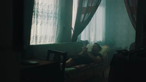 A man is resting in an old ex USSR appartment Stock Footage 131397652