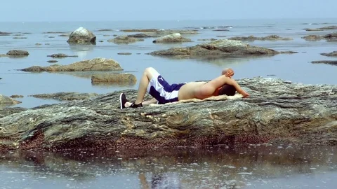 The man is resting on the reef Stock-Footage 77457200