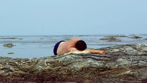 The man is resting on the reef  Stock Footage 77457212