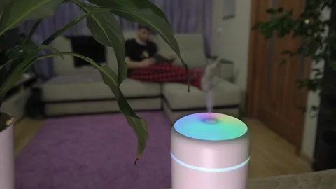 A man is resting in a room where an air humidifier is working Stock Footage 264096713