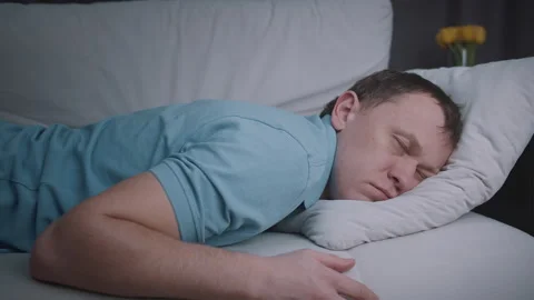 Man is resting, sleeping on the sofa, tired after a hard day. Stock Footage 316621576