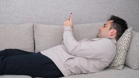 Man resting on sofa Stock Footage 273032296