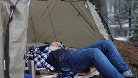 Man is resting in a tent on the shore of a winter lake Stock Footage 83145655