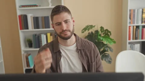 Man rests chin on hand at computer in a home office, leaning on wrist and s.. Stock Footage 337362955