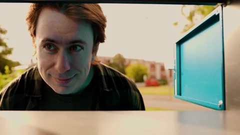 Man retrieves his order from a parcel locker. This contactless delivery service  Stock Footage 338410998