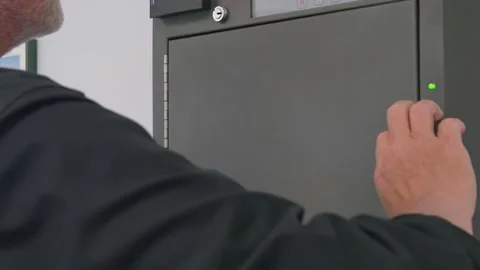 Man retrieves Key From High Tech Security Key box cabinet or locker key storage Stock Footage 161801066