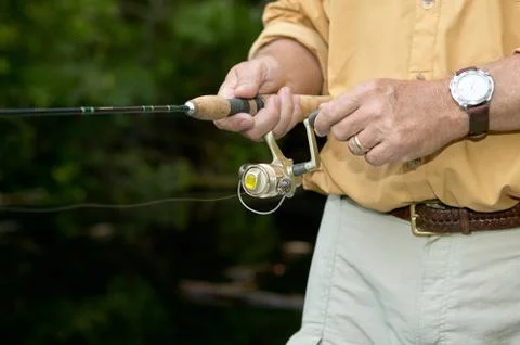 Man retrieving a lure while freshwater fishing Foto stock