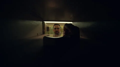 A man is retrieving mail from a safe deposit box inside a secure vault at a Stock Footage 276545051