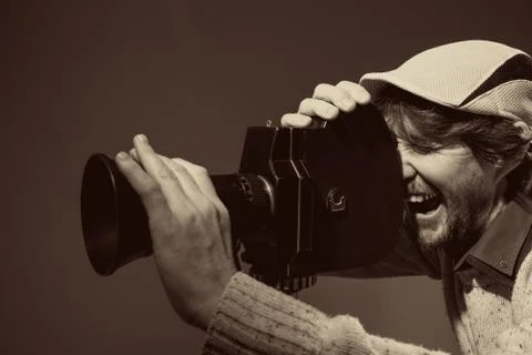 Man with retro camera. cinema operator Stock Photos