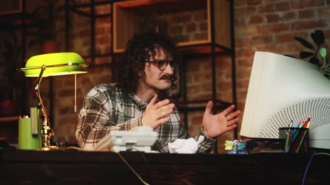 Man in retro clothes working on computer in office, facing software malfunction Stock Footage 321072338