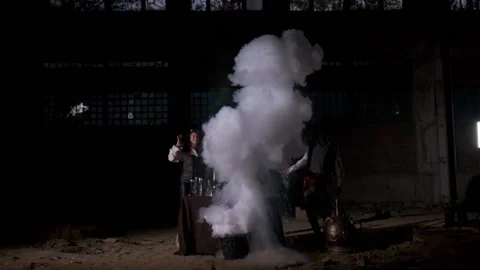 A man in a retro suit throws water into a pot. There is an explosion Stock Footage 168260626