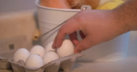 Man Returning an Egg to a Half Dozen Carton Stock Footage 101052381