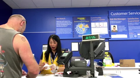Man returning goods at customer service counter inside Walmart store Stock Footage 65785430