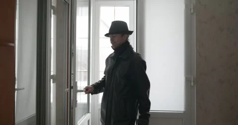 Man Returning Home. Undress Winter Attire. 4K 10-bit Stock Footage 322547230