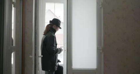 Man Returning Home. Undress Winter Attire. 4K 10-bit Stock Footage 322547260