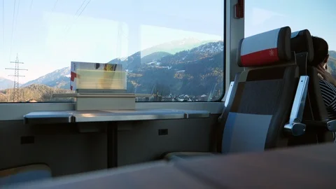Man returns to first class seat onboard Glacier Express train in Stock Footage 123148027
