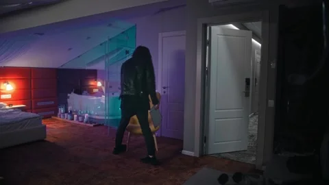 A man returns to his hotel room, throws off his outer clothes and, without Stock Footage 252274302