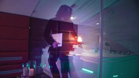 A man returns to his hotel room, throws off his outer clothes and plunges into a Stock Footage 252274558