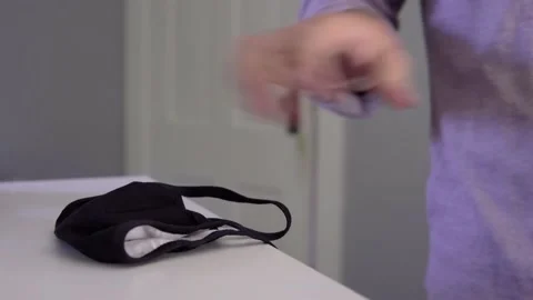 Man returns home, places face mask on desk Stock Footage 138773178