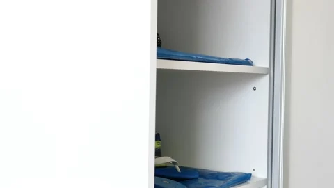 The man returns the shoes to the open closet Stock Footage 135809045