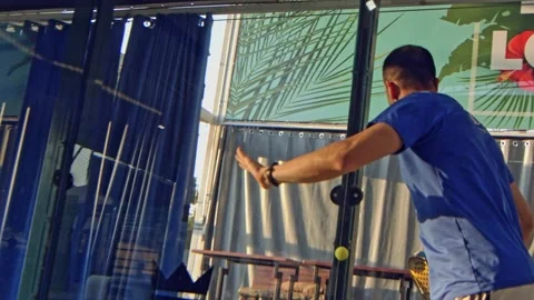 Man returns a volley off the back wall bounce in a padel game Stock Footage 203930109