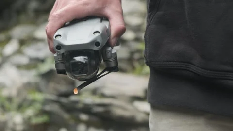 Man reveals a drone from the back Stock Footage 243390655