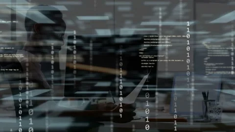 Man reviewing paper, tapping pen, causing code streams obscuring monitor then Stock Footage 335762229