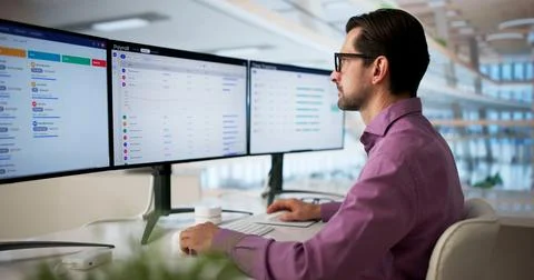 Man Reviewing Payroll Data On Computer For Accurate Employee Salary Processin Stock Photos