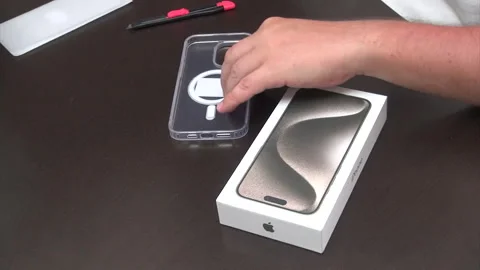 A man reviews a smartphone case and protective cover. Stock Footage 277482045