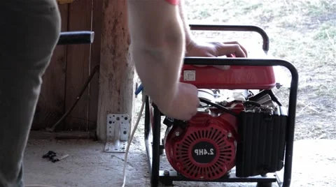 Man revolves or press some buttons on a gasoline generator Vídeos de archivo 59721836