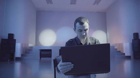 Man rewrites via laptop being alone on the nightclub Stock Footage 71474370
