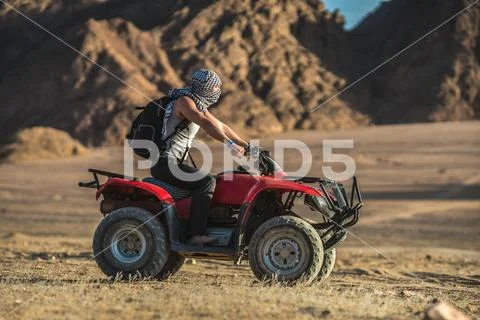 The man ride a quad bike in the desert Stock Photos